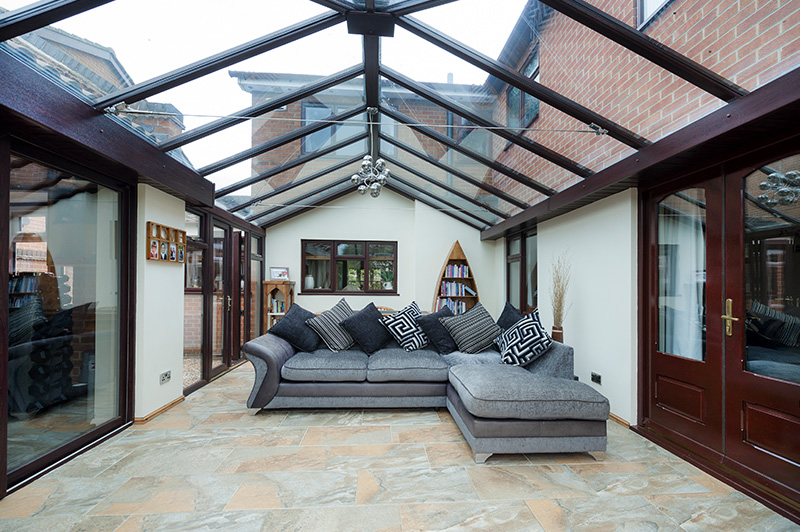 Interior of mahogany uPVC conservatory with French doors and glass roof