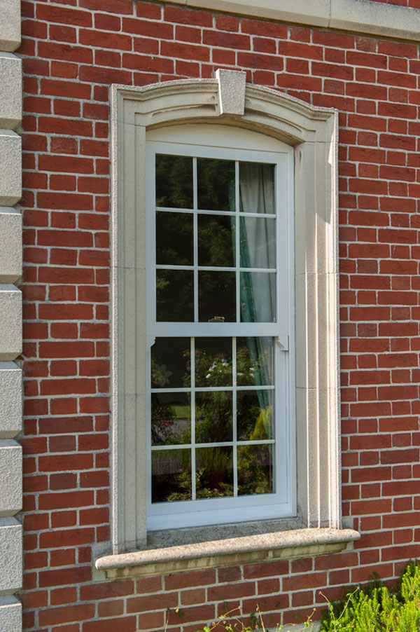 White uPVC vertical sliding sash windows with Georgian bars on a traditional property in the Leicestershire countryside.