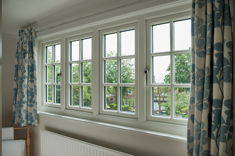 Spacious living room with white uPVC windows and Georgian bars.