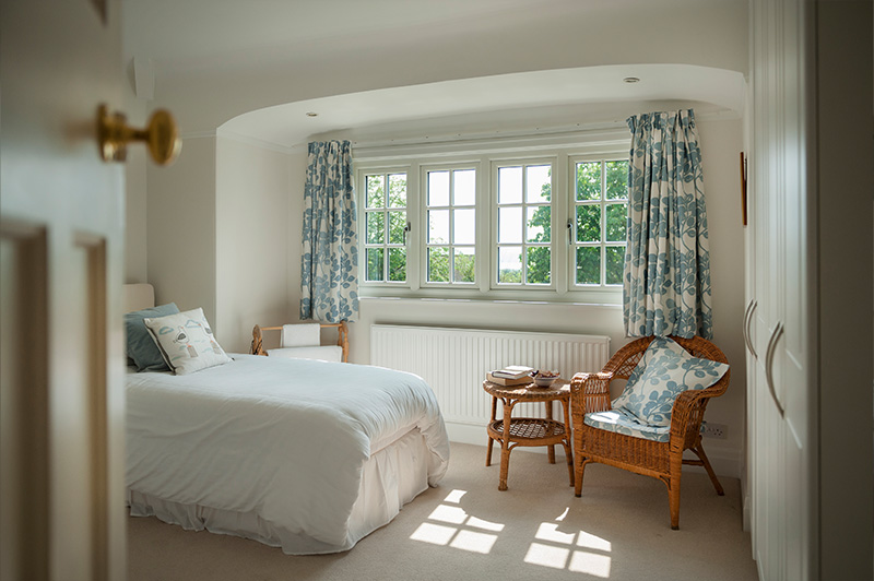 Elegant room with white uPVC windows and Georgian-style bars.