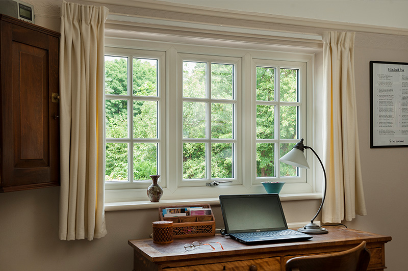 Light-filled room with white uPVC windows with Georgian bars.